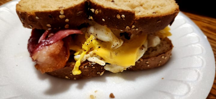 pictured are different shots of a bacon, egg, and cheese sandwich on multigrain bread.
