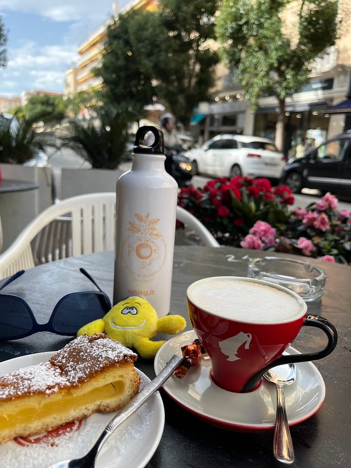 Four examples of lemon tarts and cakes in Menton, with cup of coffee. Served with ice cream, meringue, chocolate sauce and overseen by my new travelling pal, Mentonella (top right).