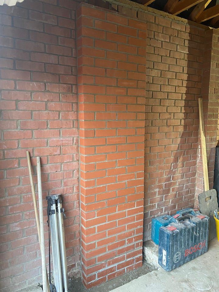 brick pillars have been constructed and brick pads added into the existing wall