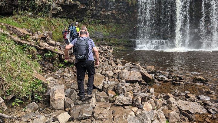 waterfalls and hikers in the brecon beacons with wales outdoors