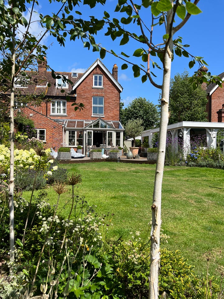 Semi detached Victorian house and garden. Square outdoor dining table