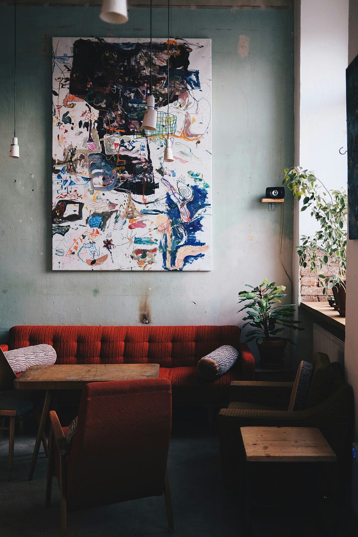 A vinyl player and a seating area with art. Photos by Dima Junglist and Alaksiej Carankievic via Unsplash.