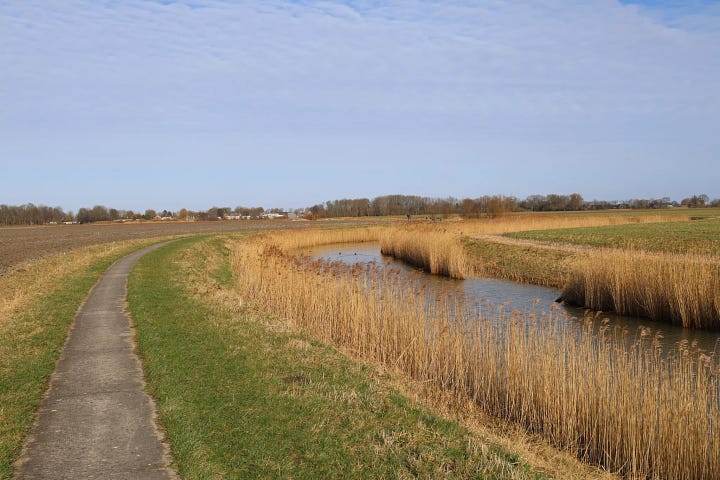 First photo shows a scenic view of the pieterpad trail along the canal, and the second image shows the route on the map