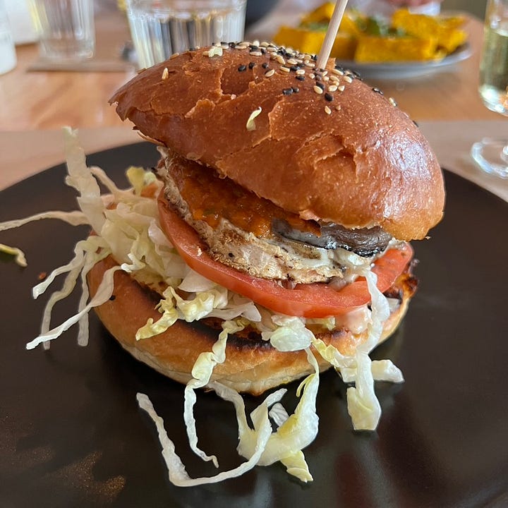Portobello mushroom burger and a slice of vegan chocolatae cake with salted caramel peanut butter