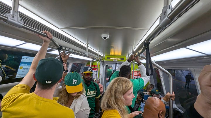 Fans crowd BART, the pedestrian walk way, and the Coliseum itself