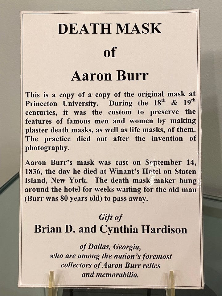 L-R: Museum placard describing the custom of making death masks and a copy of a copy of the original Burr death mask. 