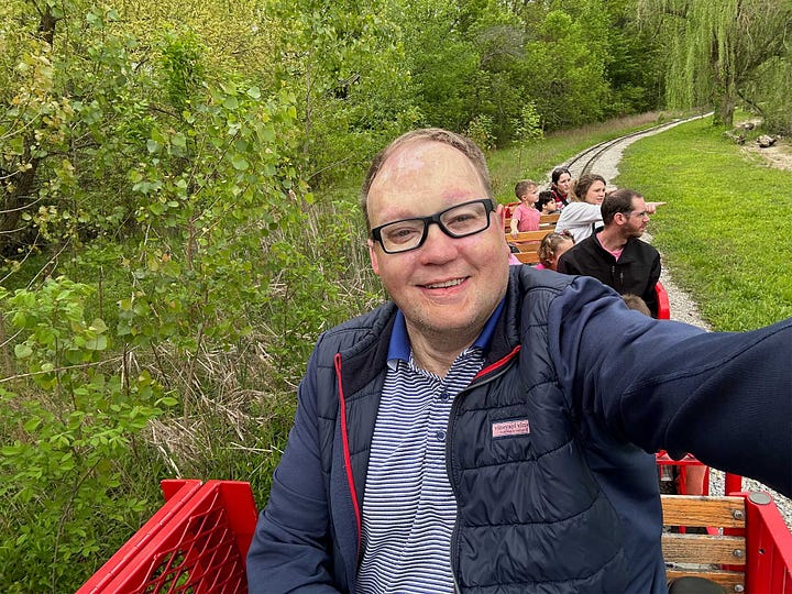 Goal ball court at Paralympic gym and selfie of John on a mini train at the zoo.