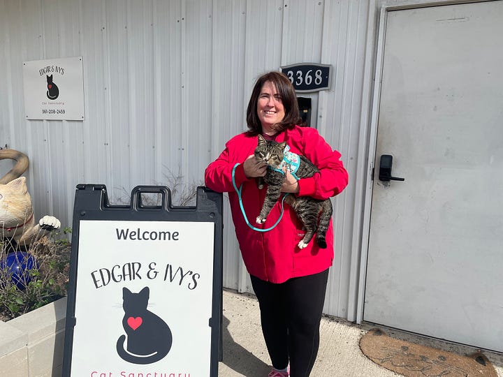 Left: Director Anissa Beal holds a rescue cat in front of Edgar & Ivy's Cat Sanctuary. Right: Spencer B. points to the new sign for the sanctuary's SB Mowing Community Wellness Center.