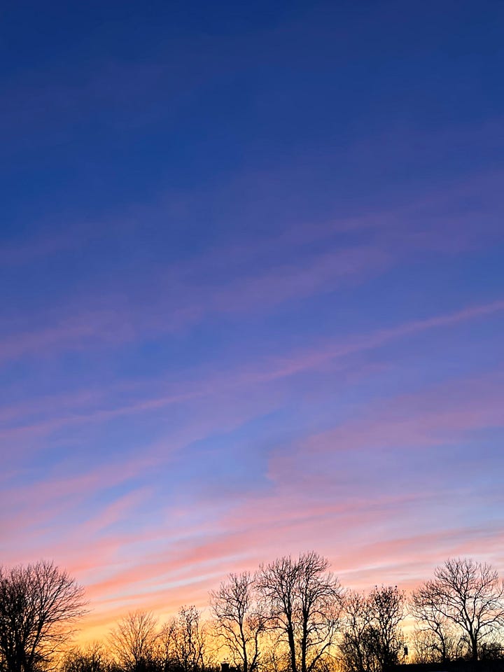 four images showing sunsets of the same view but different days, one with light blue sky and soft pink clouds, one with a dark blue sky and soft pink clouds and two with intense pink and orange clouds