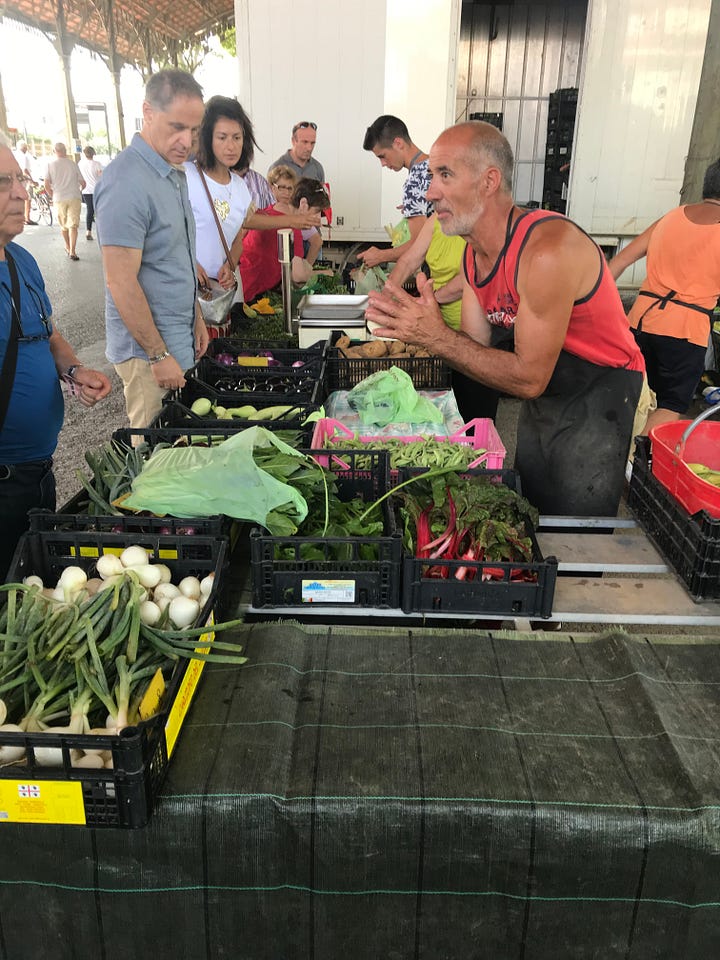 Images of a weekly Italian market, with lots of fresh produce and life