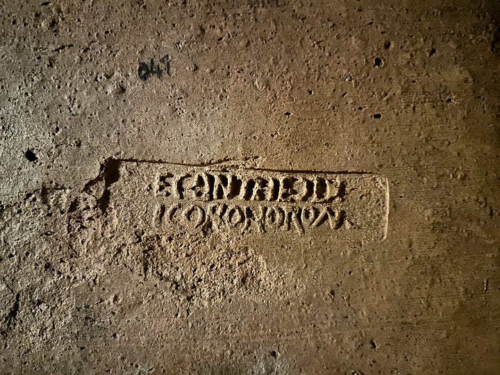 Decoration and utility in the catacombs. 1 and 2 are painted surfaces. 3 is an oil lamp in the shape of a fish embedded in the wall. 4 is more likely the name of the manufacturer of the earthenware slab than the name of the person who was buried there.