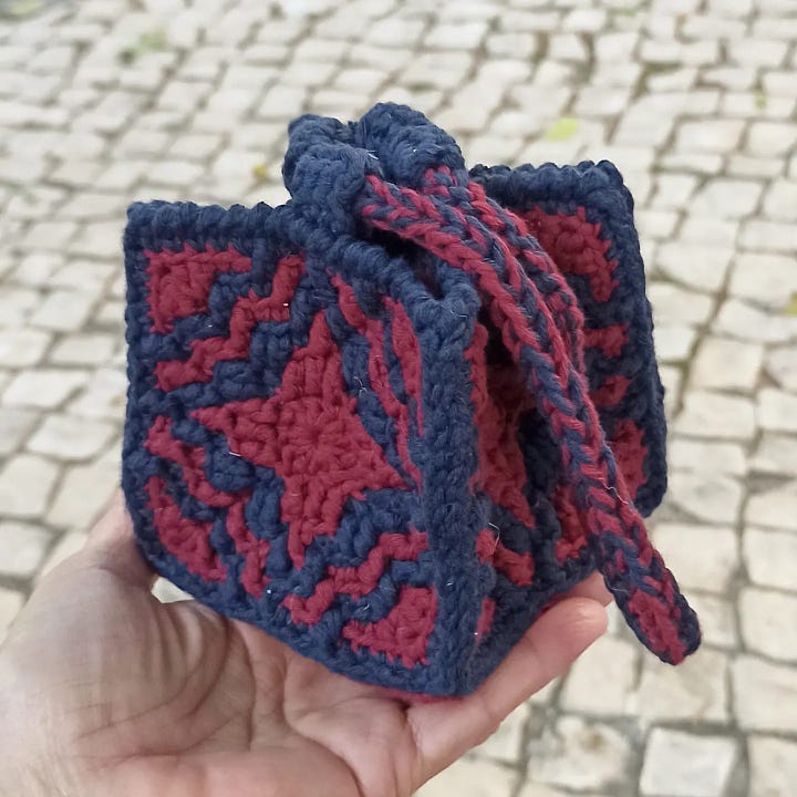 Small Komekuburo style pouch made in overlay mosaic crochet in burgundy and navy-blue.