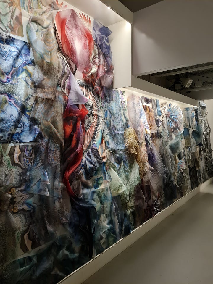 Iris Van Herpen's Sculpting the Senses exhibition display + Colorful wall of pieces of cloth
