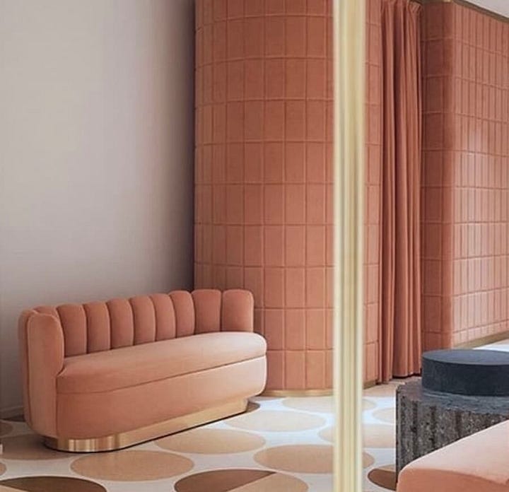 Two seating areas using varying tones of peach, from peach walls to peach furniture