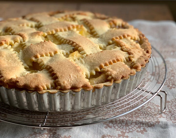 Apple Crostata and Spaghetti on serving dishes.