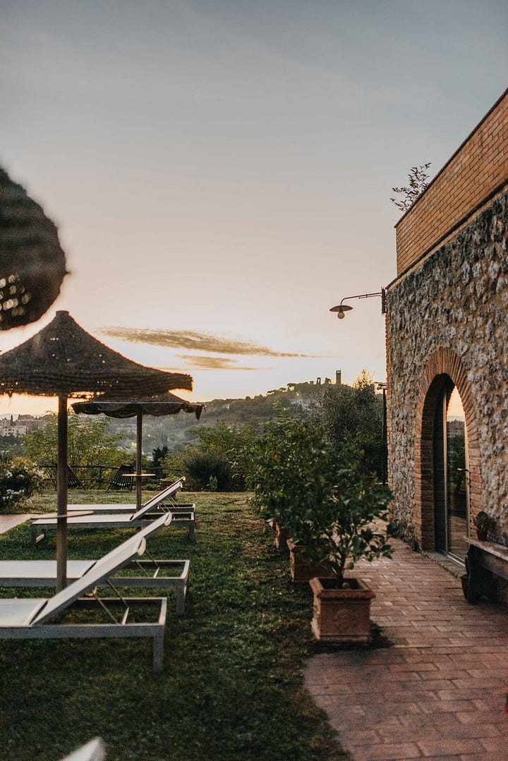 Tranquil outside space of I Pini overlooking the Tuscan town of San Gimignano