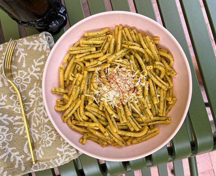 Blanched perilla, pesto ingredients in food processor, hand holding bowl of pesto, pesto pasta in a serving bowl