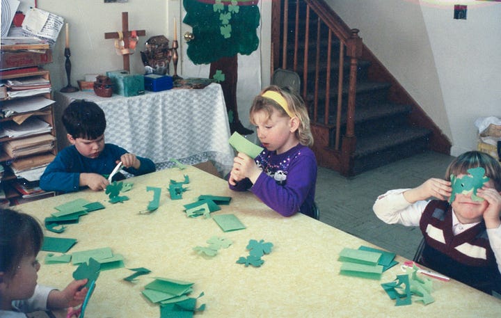 Children making paper shamrocks for St. Pat's Day