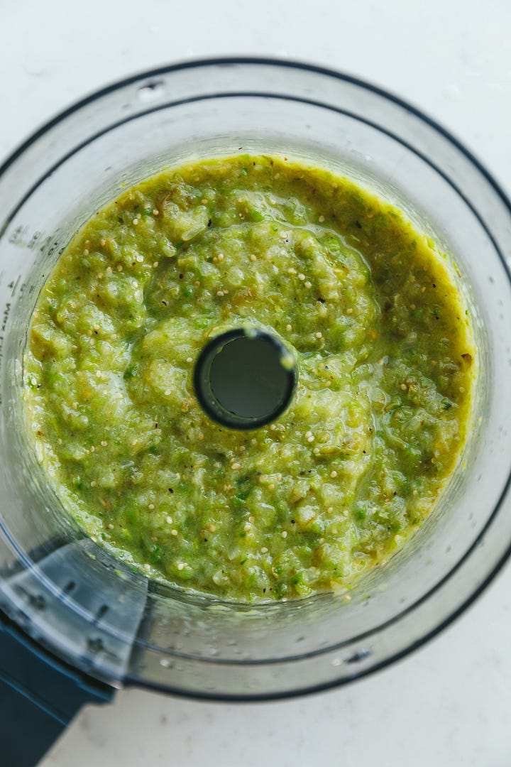 Tomatillo salsa with chicken cooking in the mixture.