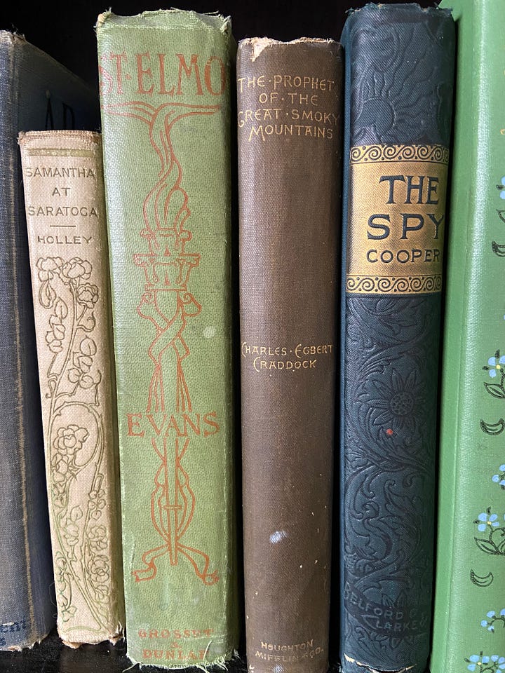 Books with decorative bindings and the author with a decorative scarf