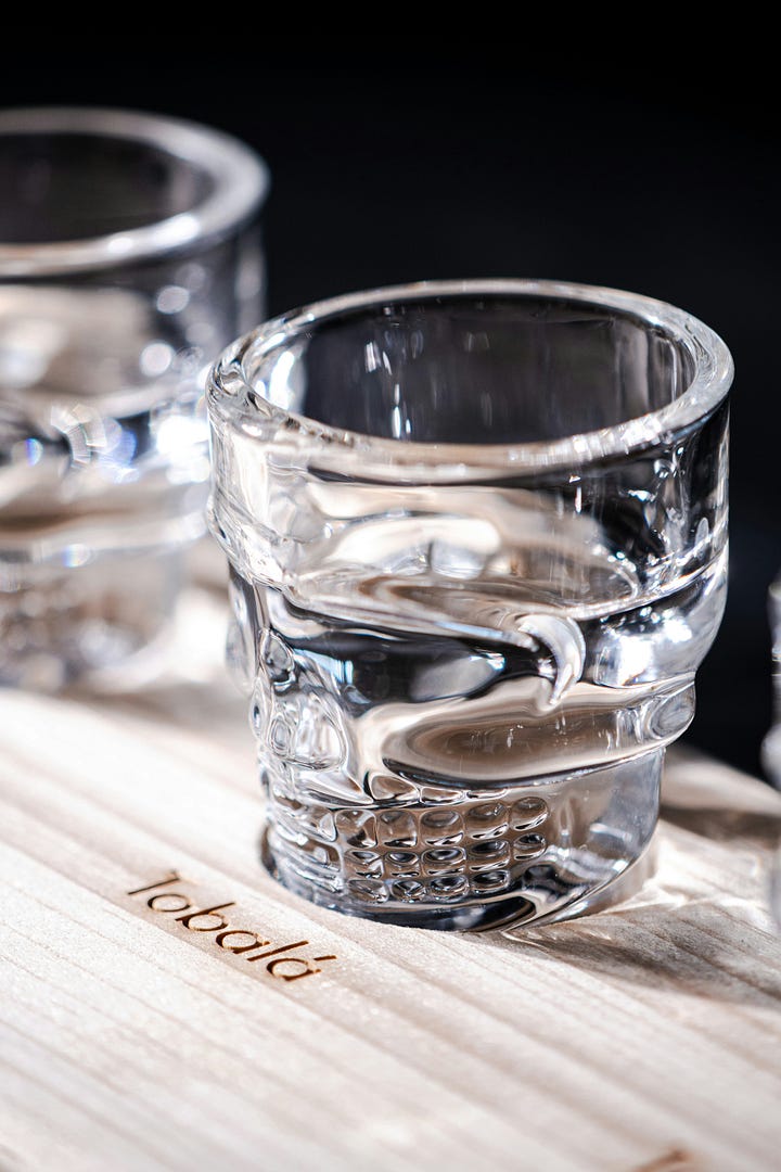 A glass of tobalá mezcal. Agave leaves. Photos by Gastro Editorial and Justin Heap, Unsplash.
