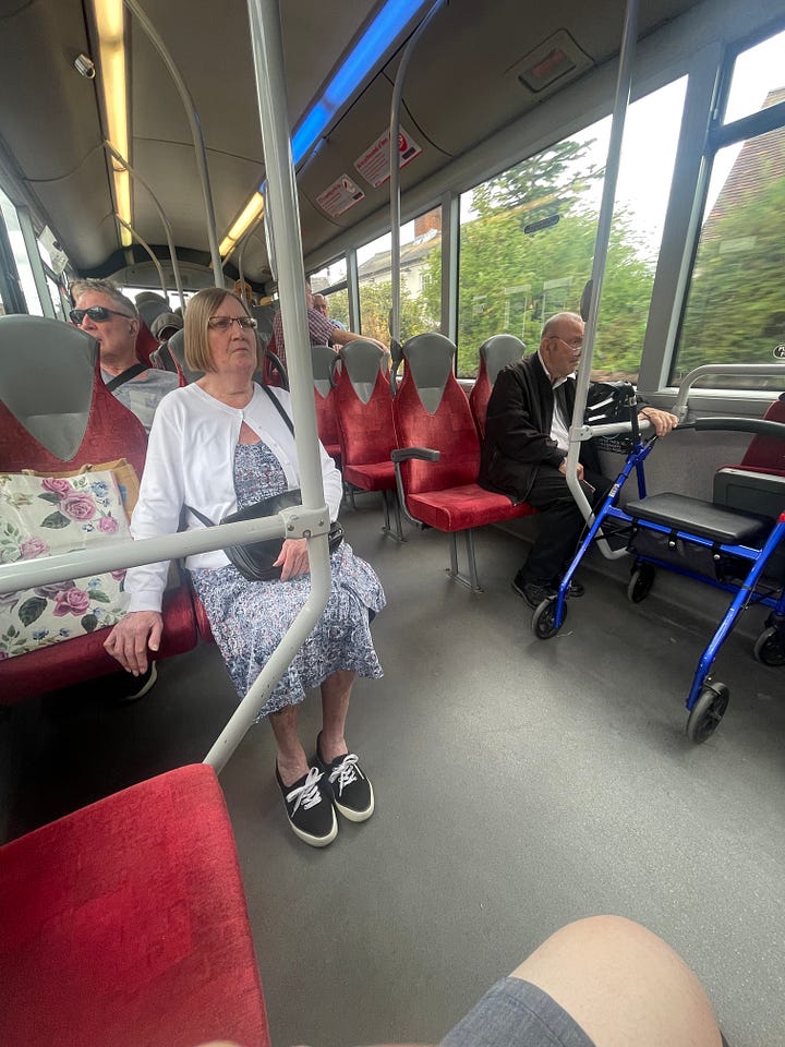 Two of the images show buses, one is blue with white stripes and the other is red. Two pictures show people sat on each bus