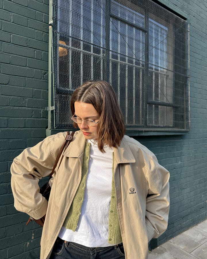 On the left, Lucy wears Carhartt stripe denim overshirt. On the right, Lucy stands in front of a green wall wearing a vintage beige golf jacket, green Sezane cardigan and white COS tee..