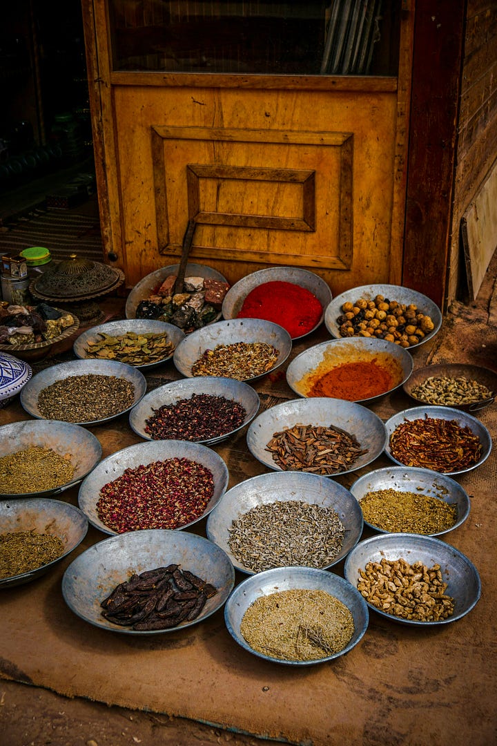 Wood fire under a grill. A table covered in spices. Photos by Bruno Forchieri and Agnieszka Stankiewicz via Unsplash.