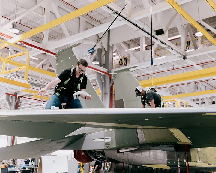 Top Left: Workers building an F-15 fighter jet at a Boeing factory in St. Louis. Worldwide military spending hit $2.2 trillion last year. Top Right: Boeing’s facilities in St. Louis. The company predicted that a larger share of its revenues and profits will come from international arms sales. Photos: Bryan Birks for The New York Times. Bottom Left: South Korea’s Chunmoo missile system was on display at the military show in Poland. Photo: Maciek Nabrdalik for The New York Times. Bottom Right: Boeing’s facilities in St. Louis. The company predicted that a larger share of its revenues and profits will come from international sales. Bryan Birks for The New York Times.