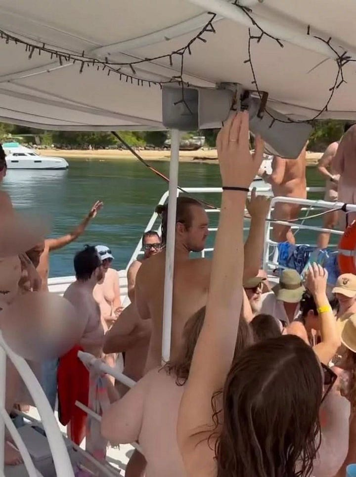 photos depict a boat full of flesh colored bodies that are obscured with excessive censor blurs.