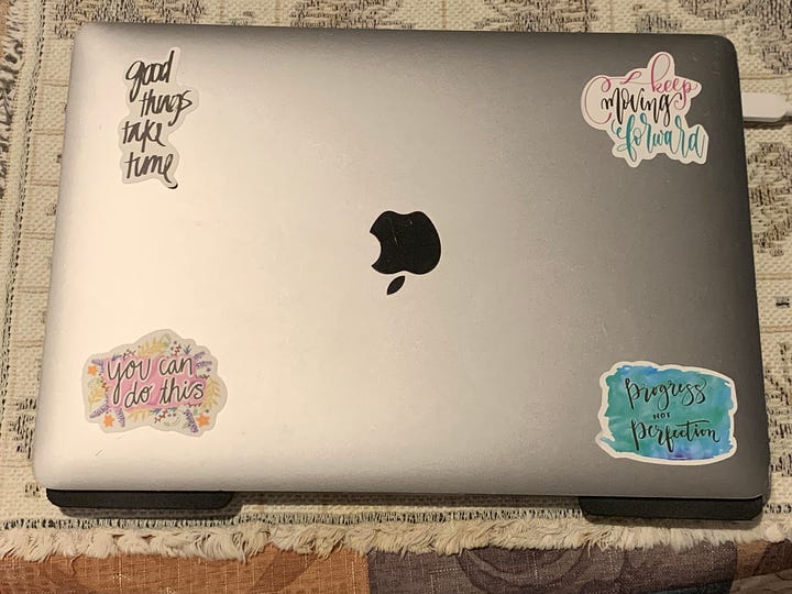 Laptop computer with inspirational stickers on it 