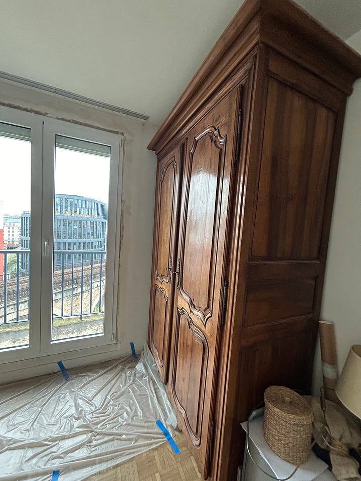 A small room with ladder and an armoire in the middle of a renovation in Paris