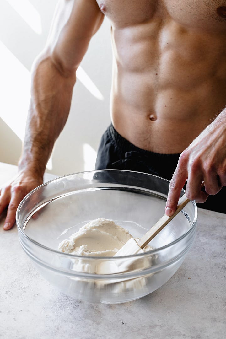 Shirtless man in black pants making vegan American buttercream step by step