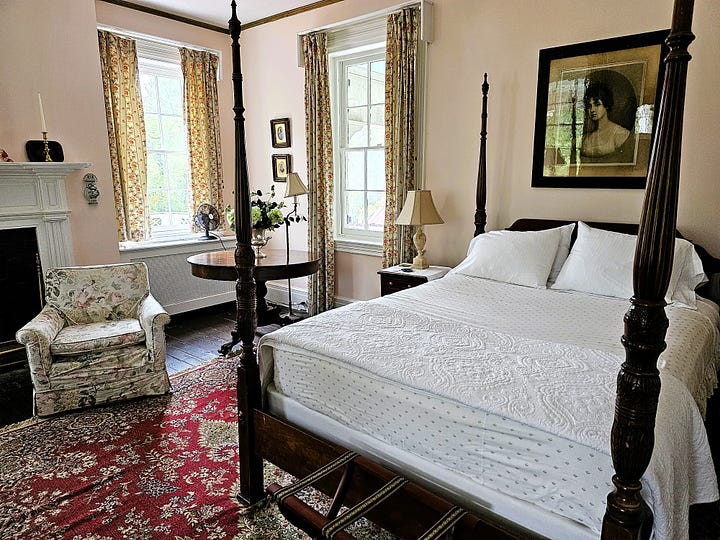 Bedroom shots, showing high four poster beds with Oriental rugs on the floor.