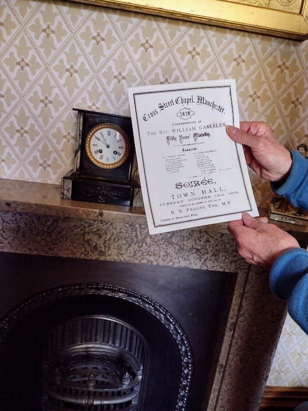 Hands holding certificate in front of fireplace, and photo of old man with little girl leaning against him