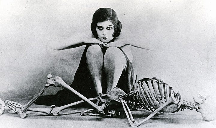 Theda Bara, born Theodosia Burr Goodman, was an American silent film and stage actress, often referred to as the first sex symbols in the history of the American film industry. Born Theodosia Burr Goodman in 1885, she took on the stage name Theda Bara— an anagram for "Arab Death". Her entire persona was a Hollywood creation, she was often pictured using Tarot cards and many of her films incorporated occult elements. Mysteriously, despite her fame, few of Bara's films have survived in a complete form. Obviously, none of this was done to meet "popular demand". Along with other bizarre silent film creatures, Goodman would be enlisted to sell war bonds and drive recruitment during WW1.