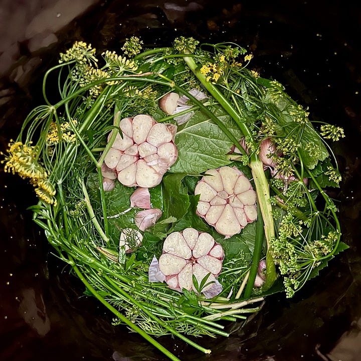 two images of inside a fermentation crock of leaves and garclic cloves, and cucumbers placed snugly