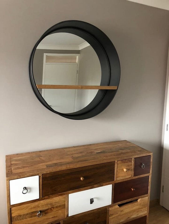 New sleek contemporary mirror compared to the original oversized porthole design mirror