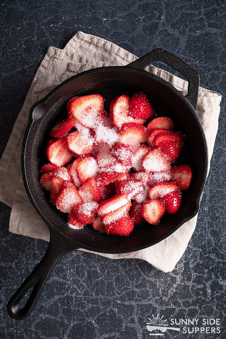 Making strawberry sauce in a skillet.