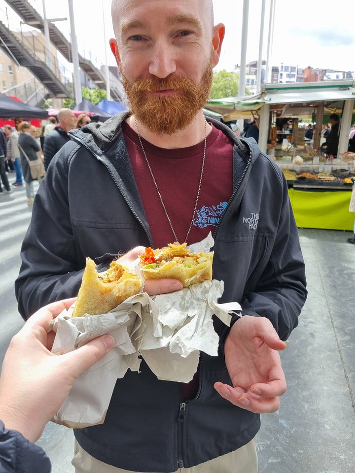 Photo 1: Aisling lining up to order msemen. Photo 2: Dave holding his wrap while Aisling taps her wrap to his from off camera.