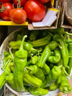 green peppers, red cherries, peaches, apricots, squash blossoms, strawberries at the market in Como, Italy