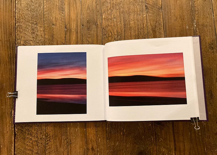A purple draft cover of the photobook, Visibility, is shown. Three 2-page spreads showing atmospheric photographs taken in all weather conditions are shown. The photos include artistic images of a lake, the driver of a car sitting in traffic during a rainstorm, and a rainy night in Minneapolis with skyscrapers reaching into the foggy haze. 