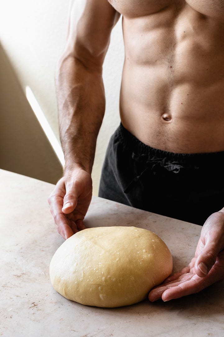 Shirtless man showing steps to make vegan olive oil brioche dough