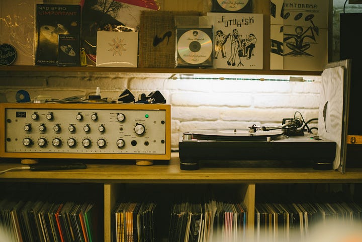 A vinyl player and a seating area with art. Photos by Dima Junglist and Alaksiej Carankievic via Unsplash.