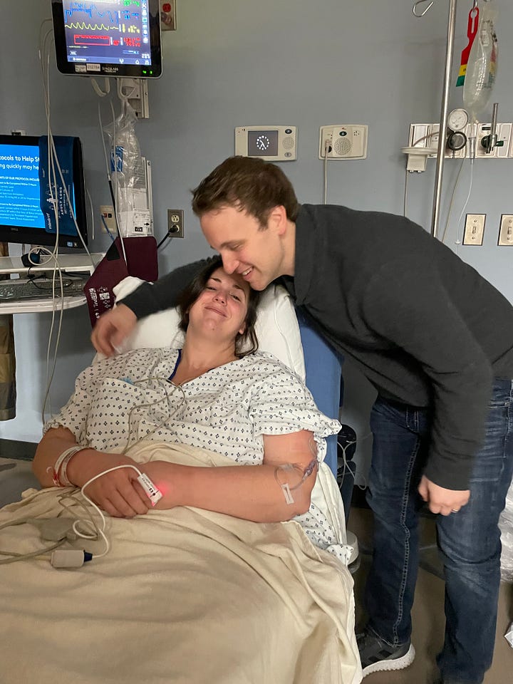 Cait in the hospital with her husband David standing next to her in first picture, kissing her forehead in second picture