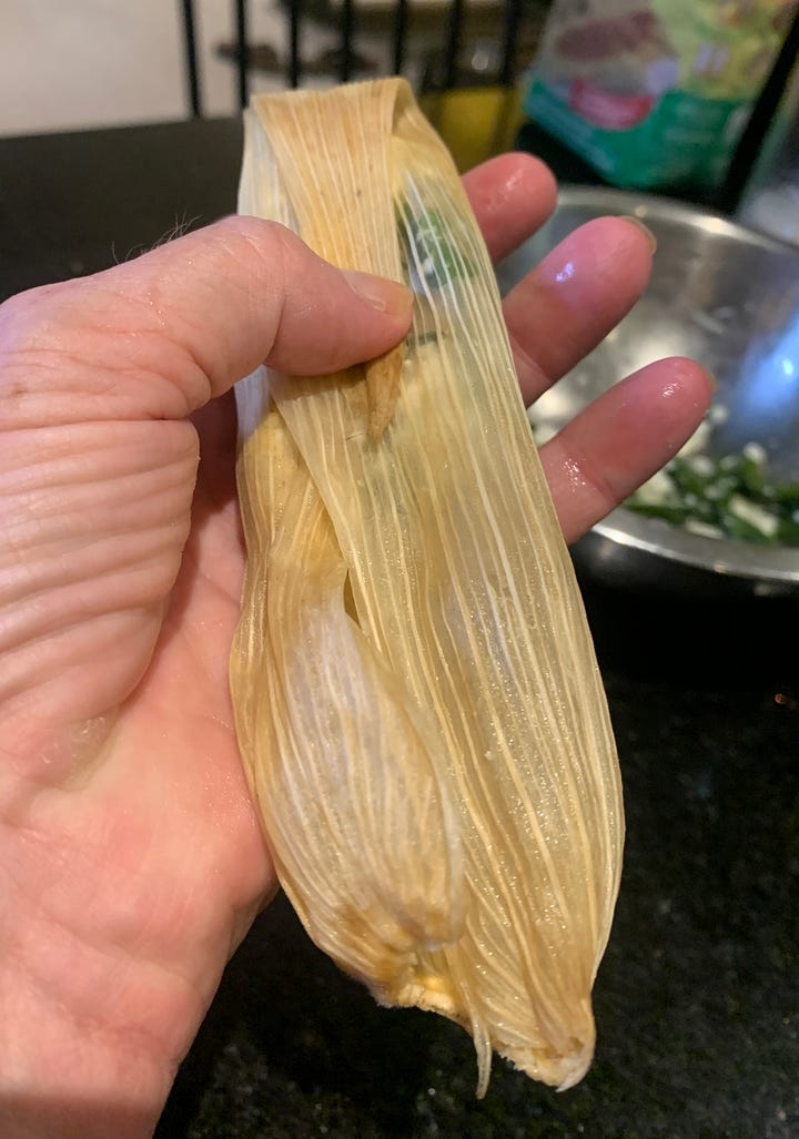 wrapping tamales in corn husks