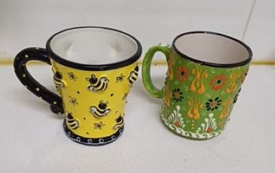 Four mugs with surface textures of lumpy, bumpy, rough, and smooth