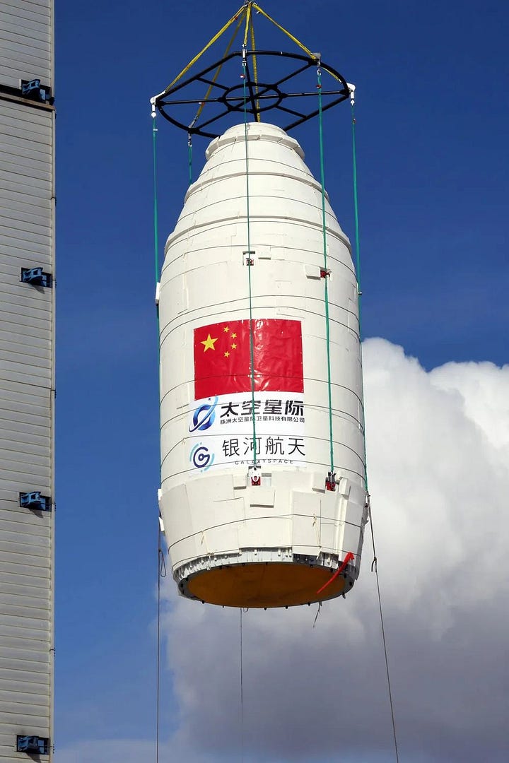 The first-stage and fairing of the Long March 2D Y99 vehicle heading to the launch pad and during integration.