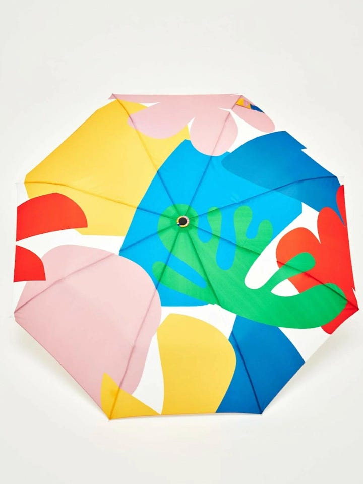 Umbrella featuring Matisse-inspired abstract shapes in bold colors, paired with a birch wood duck-head handle. A stylish, artistic choice for rainy days.