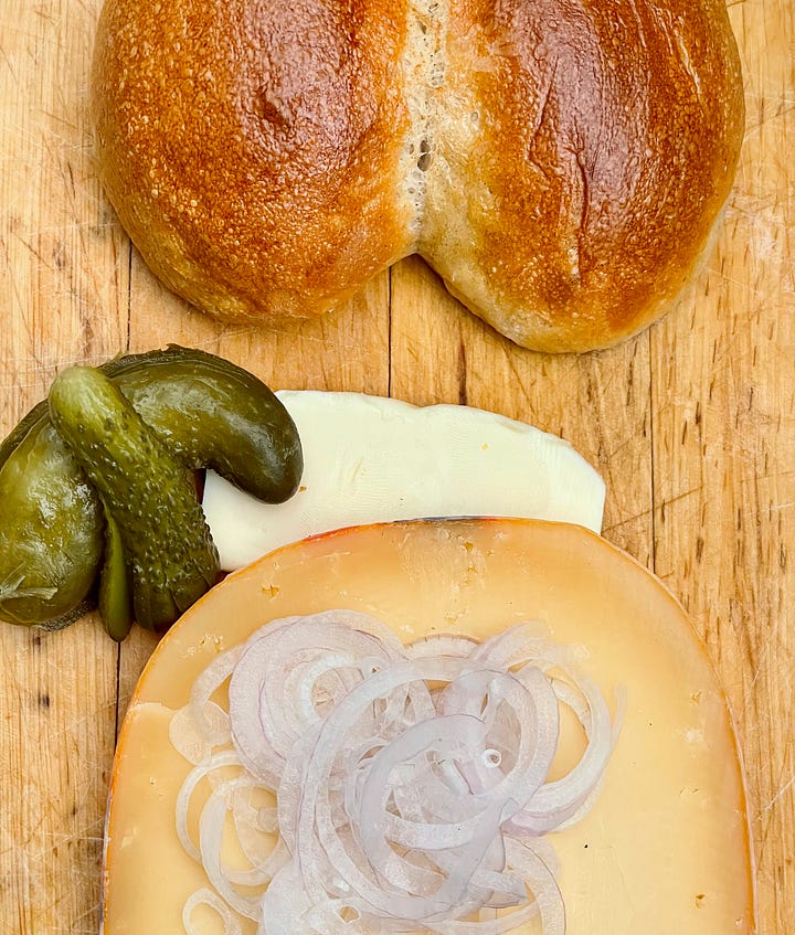 Colonge Rye Rolls and same rolls but as the Cologne Variant of a Halve Hahn with Gouda, Gerkins, Onion and Butter
